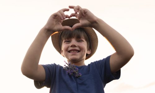 low-angle-smiley-kid-posing
